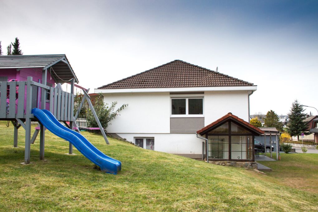 Hausansicht seitlich mit Spielplatz
